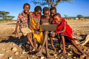 Local children learning how to use laptop